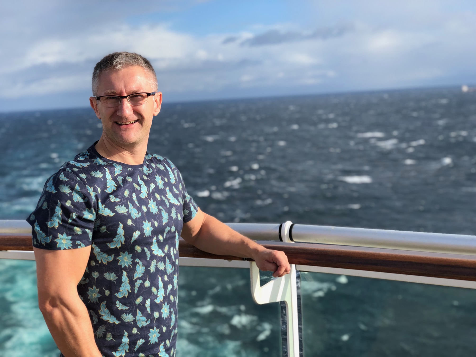 David enjoying the open deck of a cruise ship at sea
